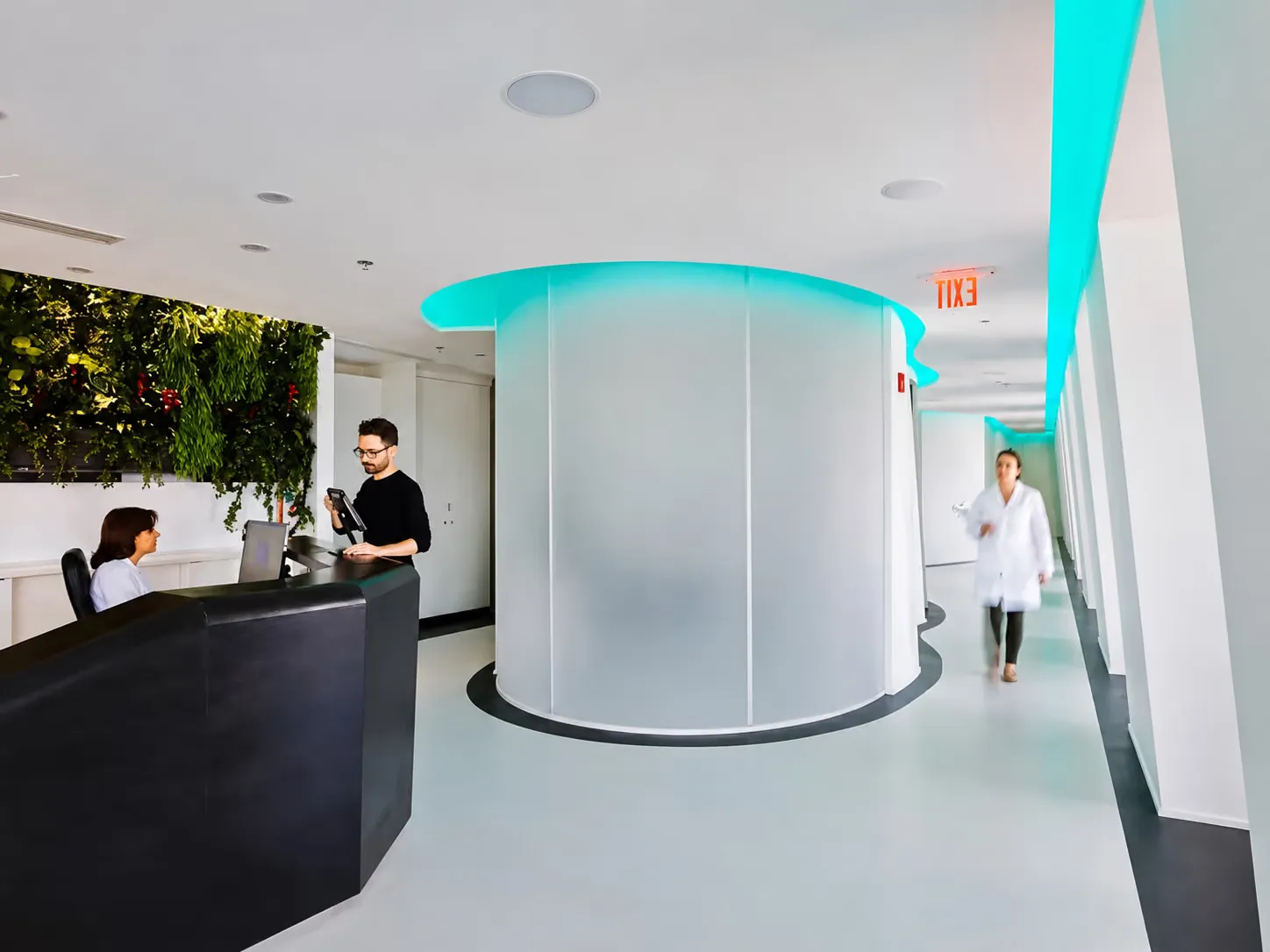 The Avanti Dentistry front desk and treatment hallway with teal cove lighting