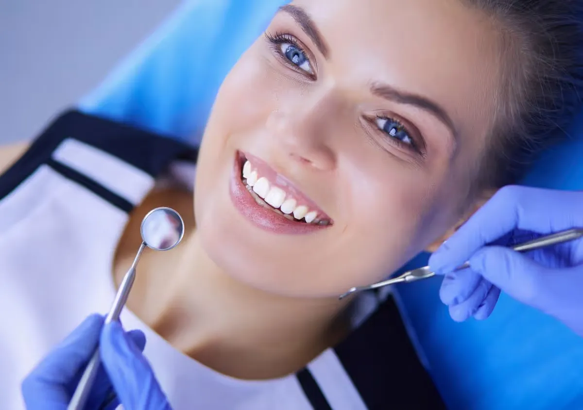 A dentist examining a patient's teeth during an urgent visit